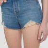 Distressed shorts in mid blue wash Distressed shorts in mid blue wash